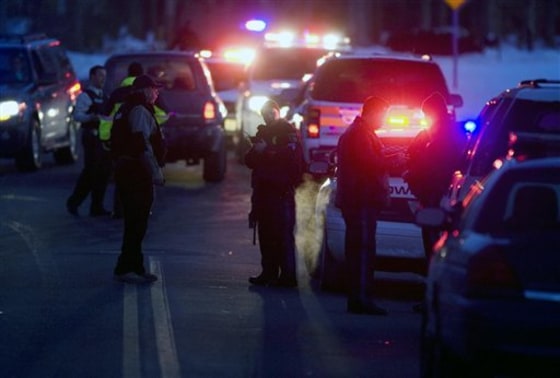 Emergency personnel respond to the scene after a police officer was shot in a townhouse complex in Lakewood, N.J., on Friday.